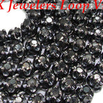 Black diamond chain necklace with a matching cross pendant in a dark metallic finish.