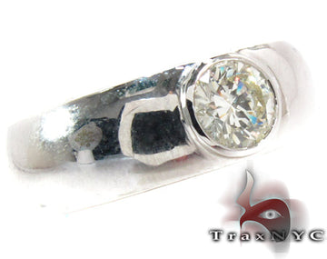 White gold men's wedding band with a single bezel-set round diamond