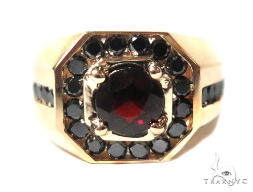 Yellow gold men's ring with central garnet gemstone and surrounding black stones