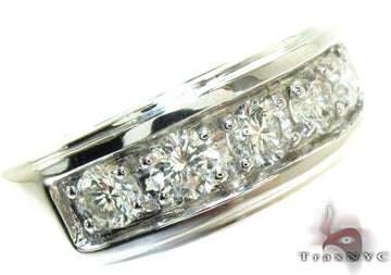 Men’s white gold wedding band with five prong-set round diamonds in a row.