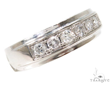White gold men's wedding band with a row of prong-set round diamonds