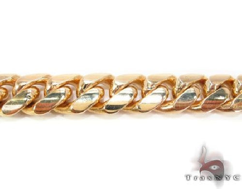 Solid 10k yellow gold Miami Cuban link chain, 15.5mm wide 30 inch length, flat lay showing tight interlocked links