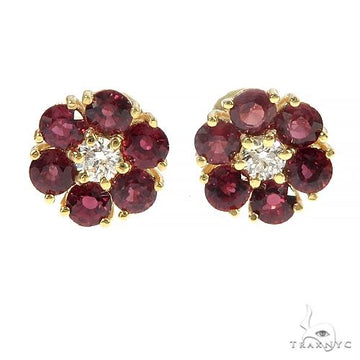 Mini flower earrings with crimson sapphire petals and central diamond in yellow gold setting.