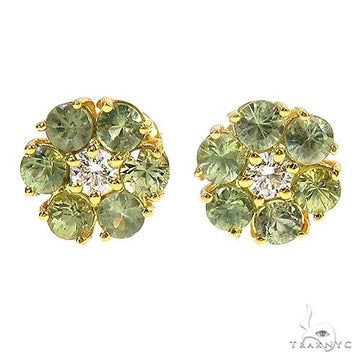 Yellow gold flower cluster earrings with green sapphires and central diamond accents.