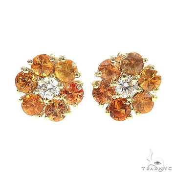 Mini flower cluster earrings with orange sapphires and center diamond in yellow gold.