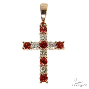 Mini gold cross pendant with red sapphires and small round diamonds.