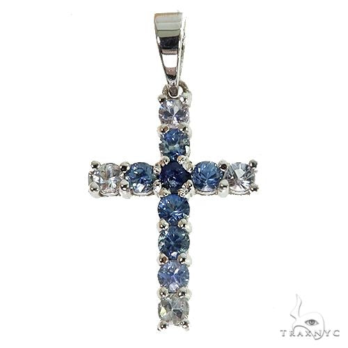 Mini sapphire cross pendant – water-toned blue gemstones set in a small cross silhouette, front view