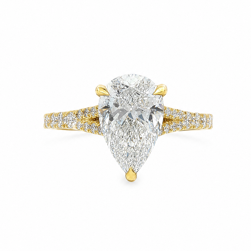 Pear cut 2 carat diamond engagement ring with three-prong setting and pave band