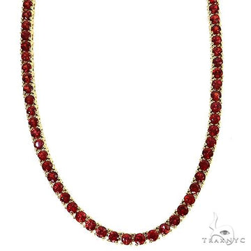 Yellow gold tennis chain necklace with round vivid red sapphire stones.