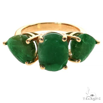 Yellow gold ring with three oval emerald gemstones set side by side.