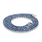 White gold tennis chain necklace with round blue sapphire gemstones, elegant and classic design.