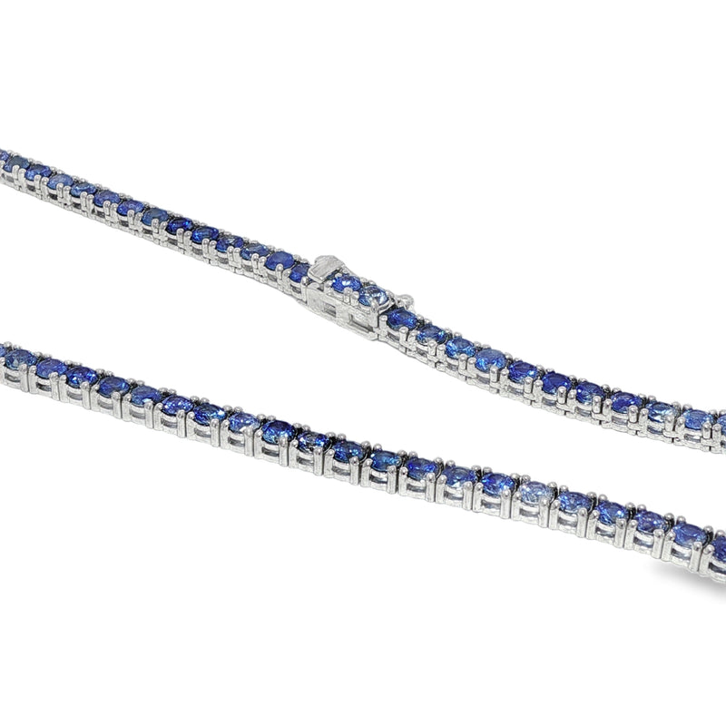 White gold tennis chain necklace with round blue sapphire gemstones, elegant and classic design.
