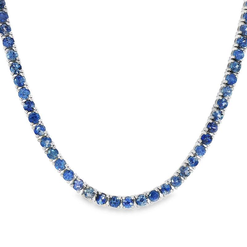 White gold tennis chain necklace with round blue sapphire gemstones, elegant and classic design.