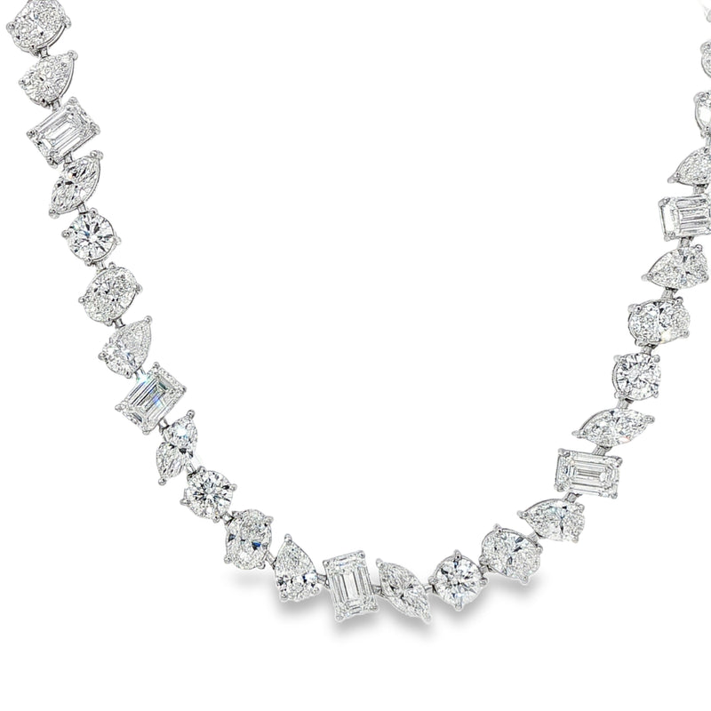 White gold diamond tennis chain with multi-shaped stones in a continuous link design.