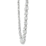 White gold diamond tennis chain with multi-shaped stones in a continuous link design.