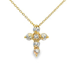 Yellow gold upside-down cross necklace with clear and yellow diamonds in a cluster design.