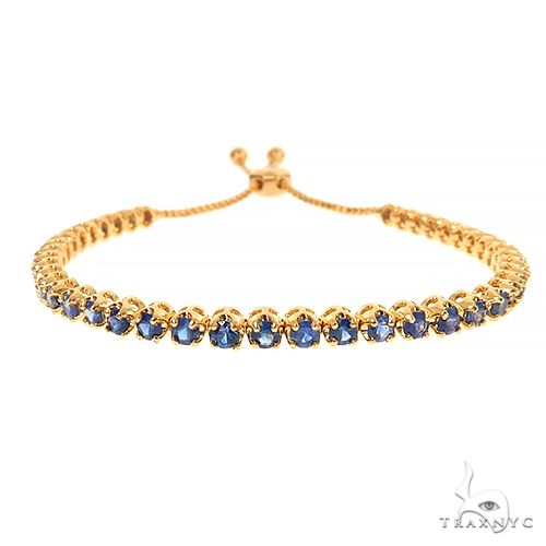 Yellow gold adjustable tennis bracelet with round blue sapphire gemstones