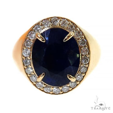 Yellow gold ring with large oval sapphire surrounded by small diamonds.