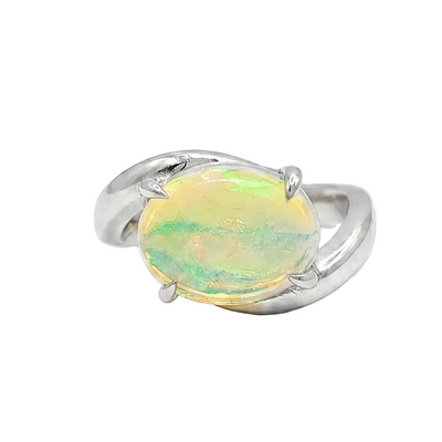 Silver pinky ring with oval opal gemstone in a bypass setting.