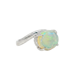 Silver pinky ring with round iridescent opal gemstone and bypass band design.