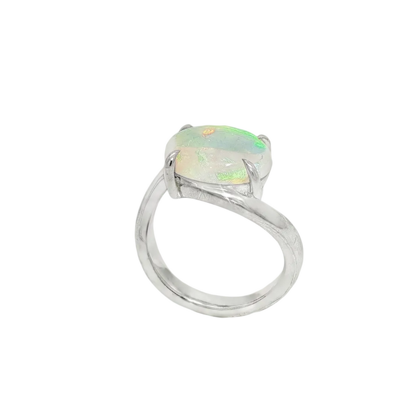 Silver bypass ring with oval opal gemstone, delicate and elegant pinky ring design.
