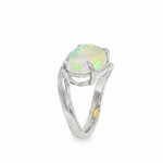 Silver pinky ring with oval opal gemstone and elegant bypass band design.