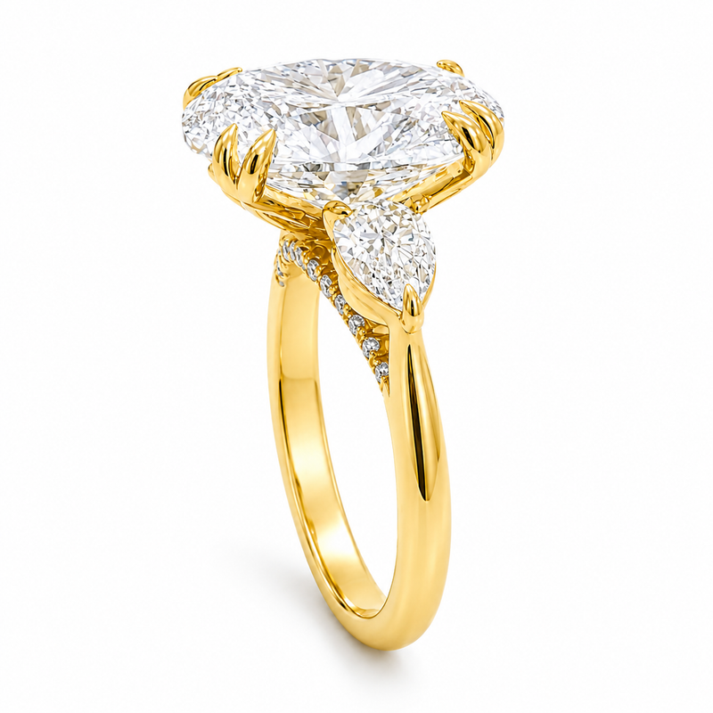 Oval three stone engagement ring with oval lab grown diamond, double claw prongs, tulip basket, and pear side diamonds