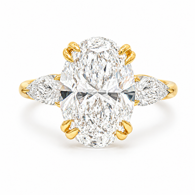 Oval three stone engagement ring with oval lab grown diamond, double claw prongs, tulip basket, and pear side diamonds