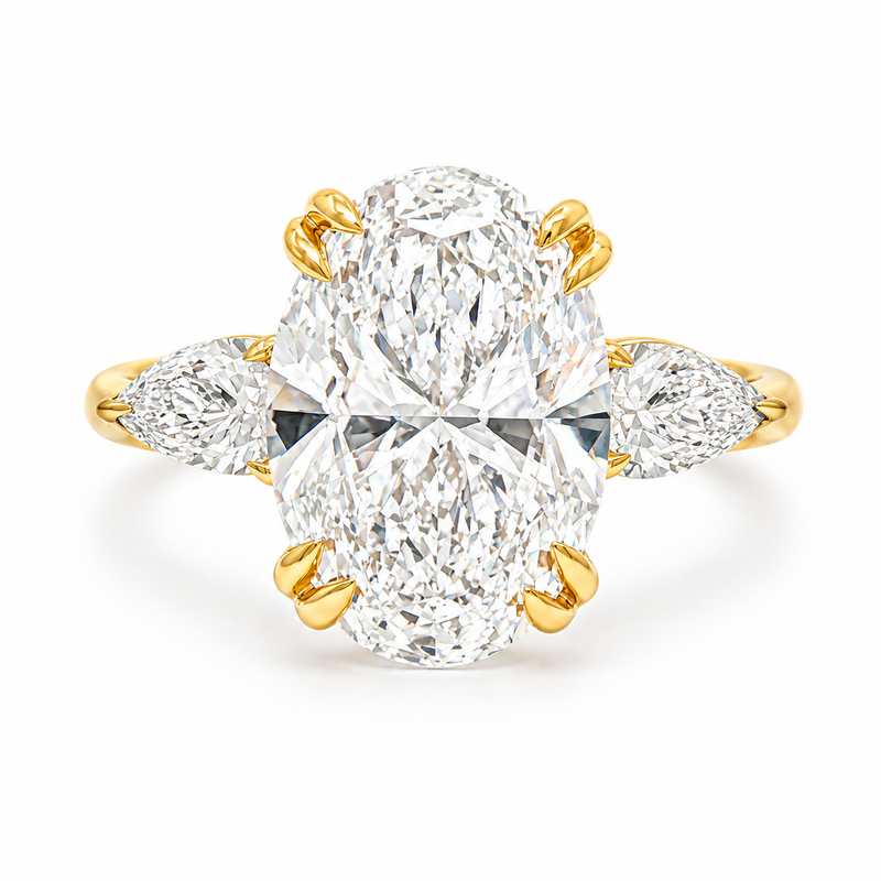 Oval three stone engagement ring with oval lab grown diamond, double claw prongs, tulip basket, and pear side diamonds