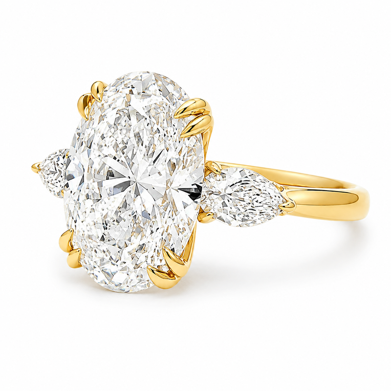Oval three stone engagement ring with oval lab grown diamond, double claw prongs, tulip basket, and pear side diamonds