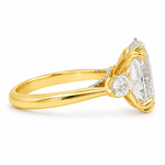 Oval three stone engagement ring with oval lab grown diamond, double claw prongs, tulip basket, and pear side diamonds