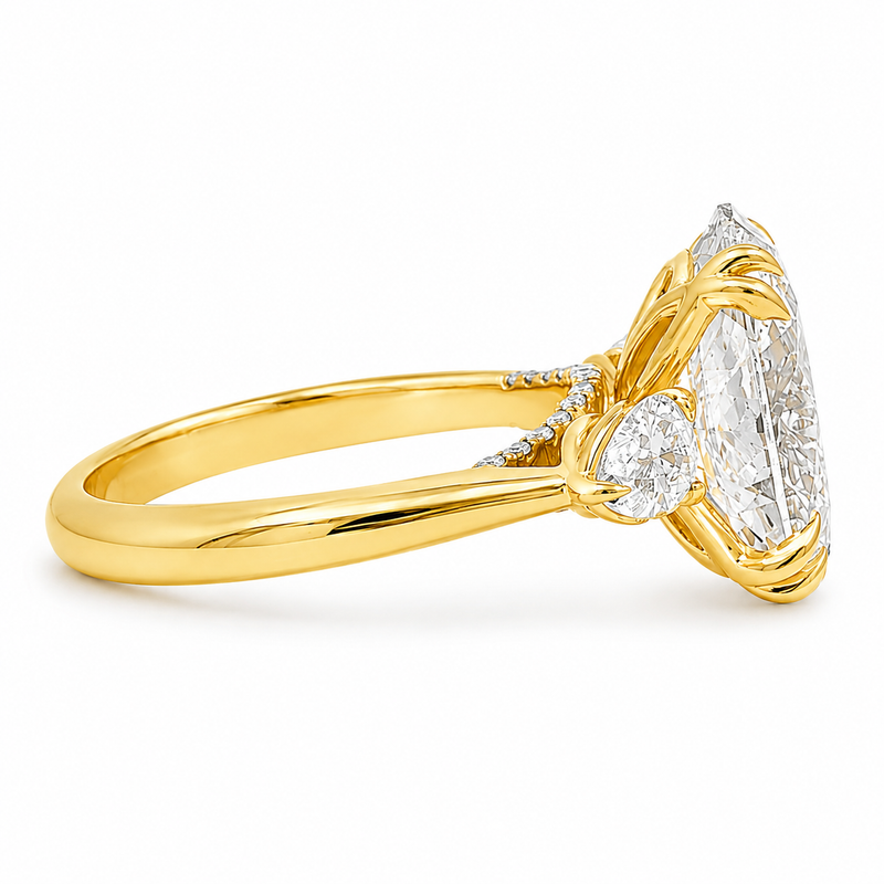 Oval three stone engagement ring with oval lab grown diamond, double claw prongs, tulip basket, and pear side diamonds