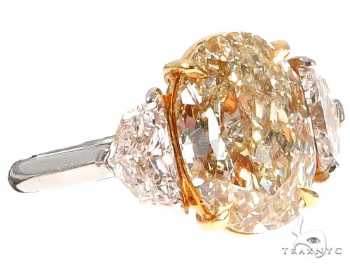 Oval diamond engagement ring in yellow gold – oval center stone in four-prong solitaire setting, top-down view