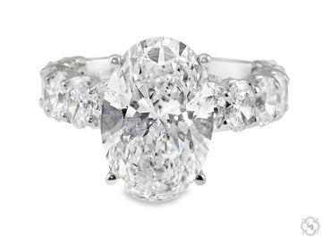 Oval diamond engagement ring with oval center stone set in metal band – front profile view
