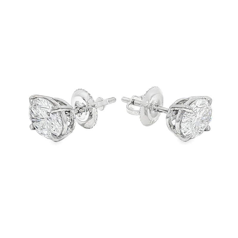 Pair of oval diamond stud earrings with cluster setting in white gold prong mount