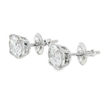 Pair of oval diamond stud earrings with cluster setting in white gold prong mount