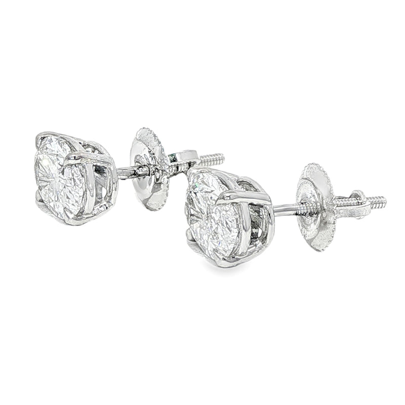 Pair of oval diamond stud earrings with cluster setting in white gold prong mount