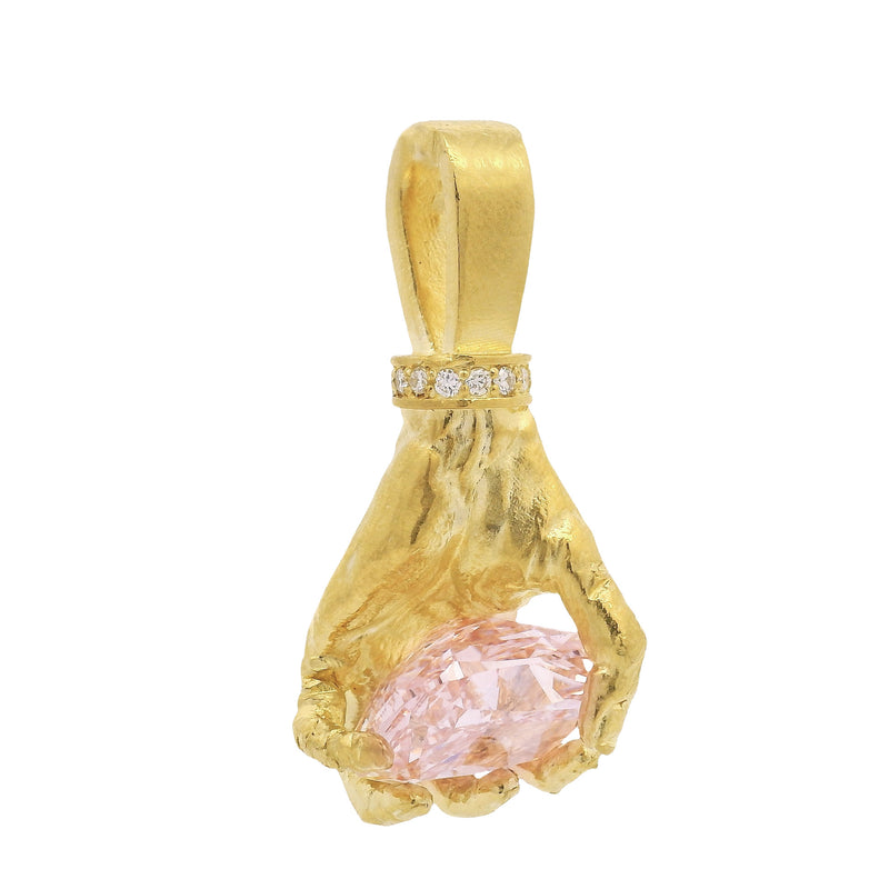 Gold hand pendant with pink diamond and small white diamonds on bail.