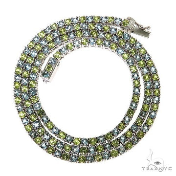 Yellow gold tennis chain with alternating peridot and aquamarine gemstones, unisex design.