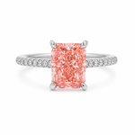 White gold engagement ring featuring a radiant-cut pink lab grown diamond, pavé diamond band, and diamond hidden halo.
