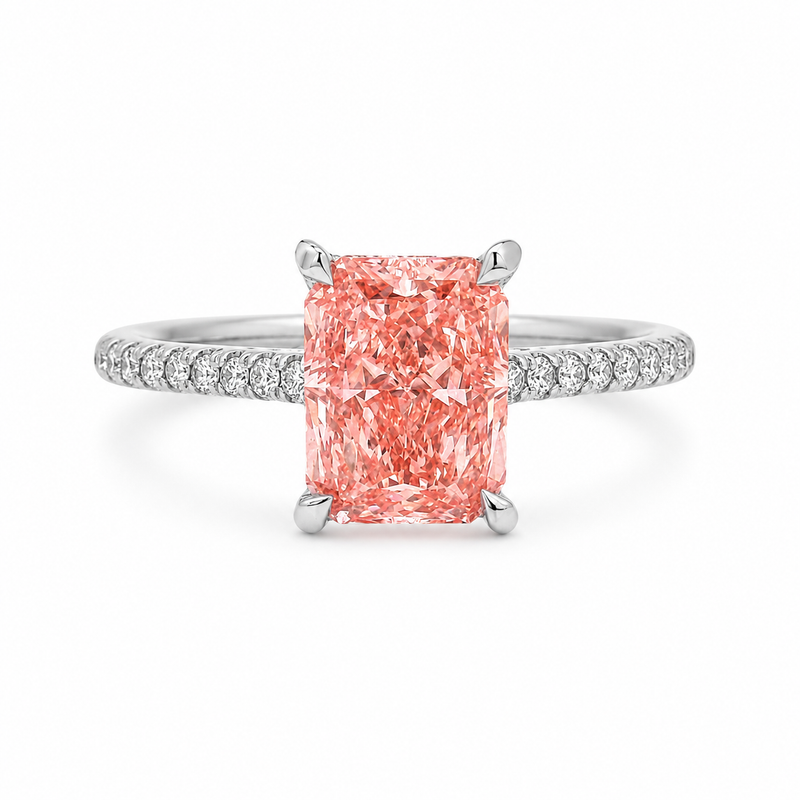 White gold engagement ring featuring a radiant-cut pink lab grown diamond, pavé diamond band, and diamond hidden halo.
