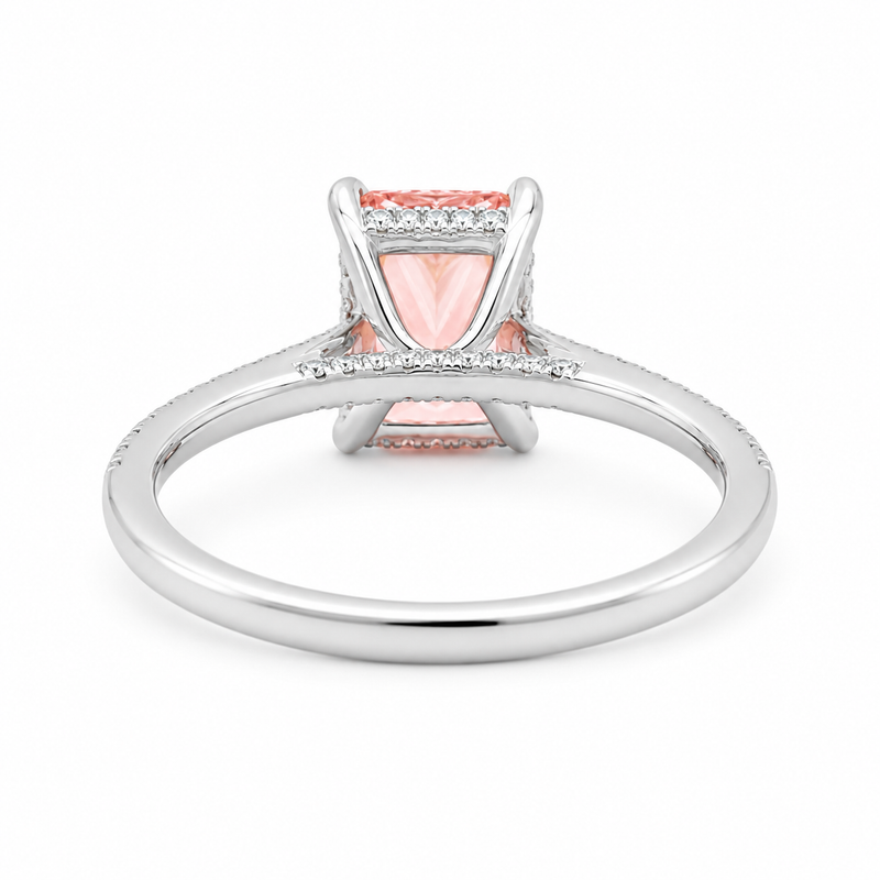 White gold engagement ring featuring a radiant-cut pink lab grown diamond, pavé diamond band, and diamond hidden halo.
