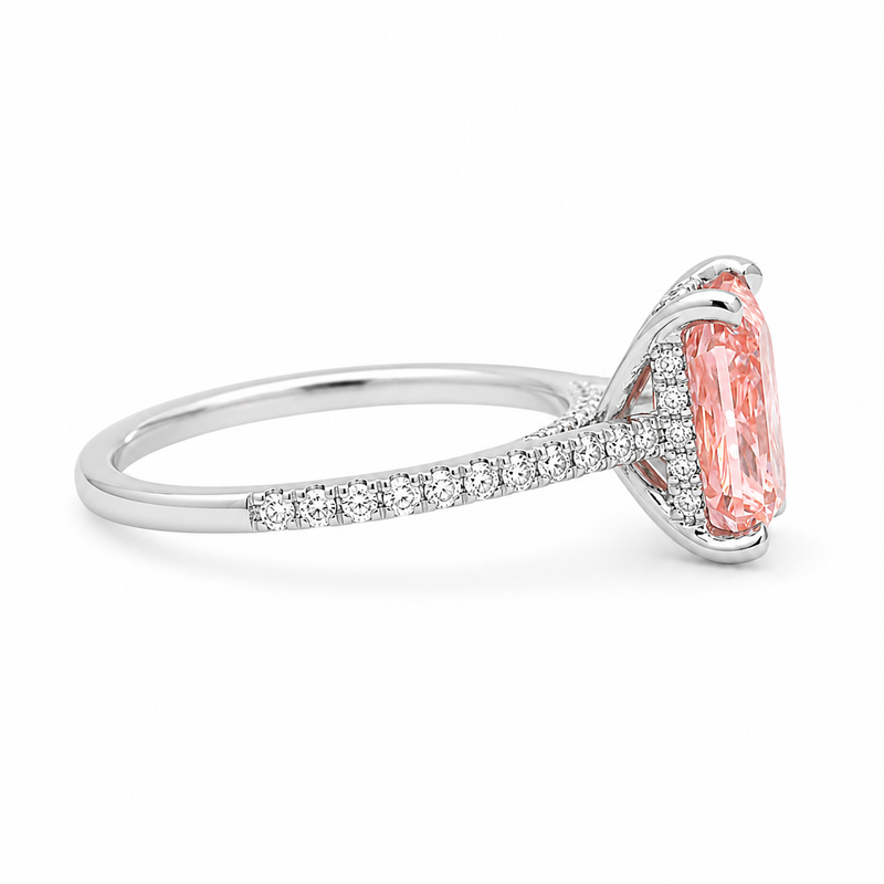 White gold engagement ring featuring a radiant-cut pink lab grown diamond, pavé diamond band, and diamond hidden halo.