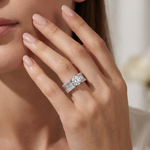 Princess cut diamond engagement ring with baguette side stones on silver band.