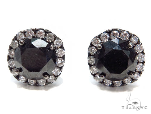 Round black diamond stud earrings with halo of smaller clear diamonds in prong setting