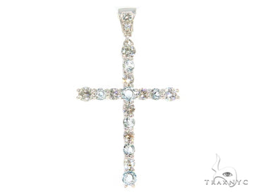 White gold cross pendant with prong-set diamonds and aquamarine gemstones.