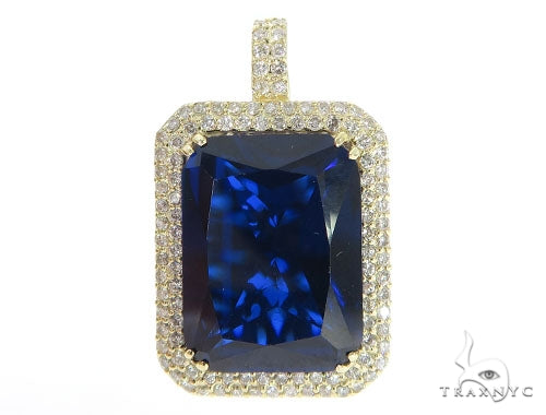 Prong-set deep blue diamond pendant framed with yellow gold and small round diamonds