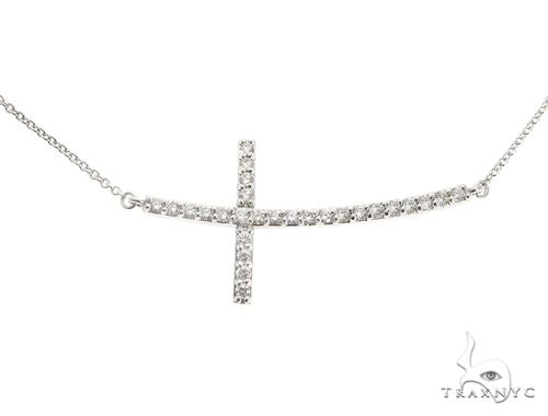 White gold prong-set diamond cross pendant on delicate chain, modern horizontal design