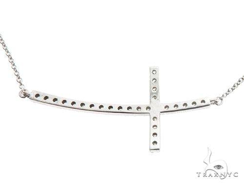 White gold prong-set diamond cross pendant with delicate chain, minimalist design