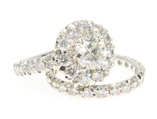 Engagement ring set with a round prong-set center stone and fitted band